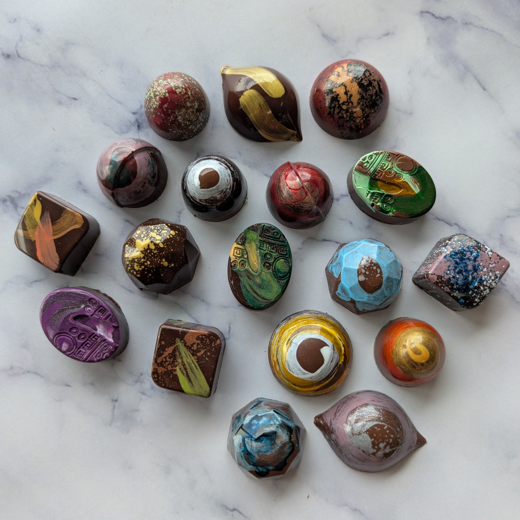 Assorted colorful chocolates on a marble surface