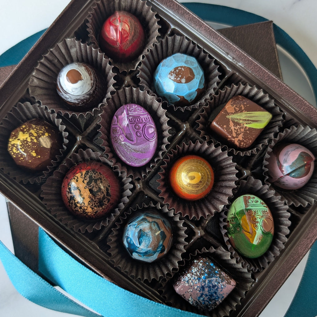 Assorted colorful chocolates in a brown box on a marble surface.  signature collection
