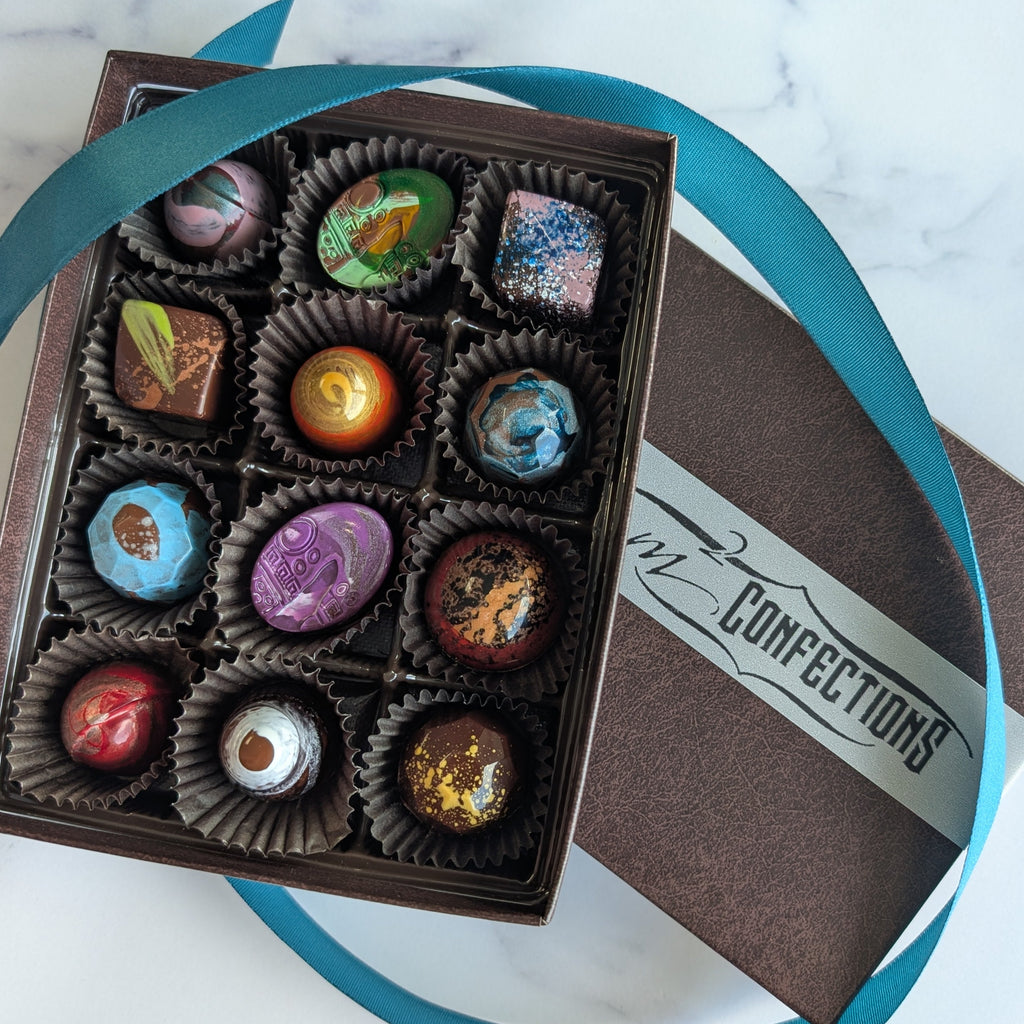 Box of assorted chocolates with a visible brand name on a marble surface