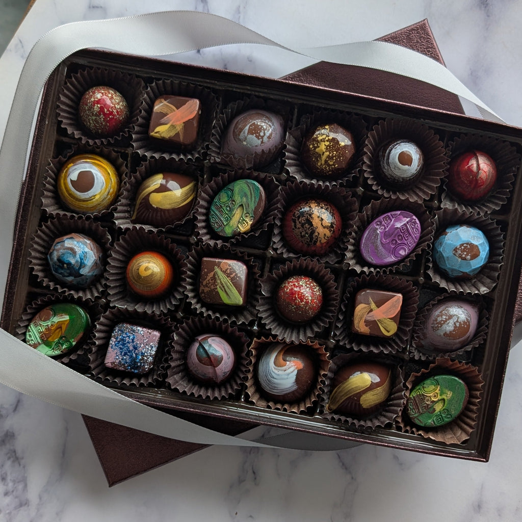 Box of assorted chocolates on a marble surface